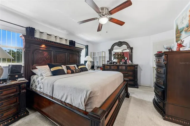 a bed room with a bed and a flat tv screen