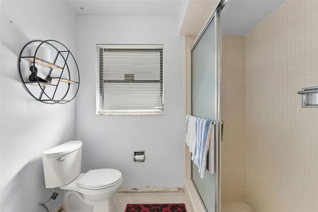 a bathroom with a toilet and a mirror
