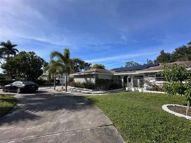 a front view of house with yard and green space