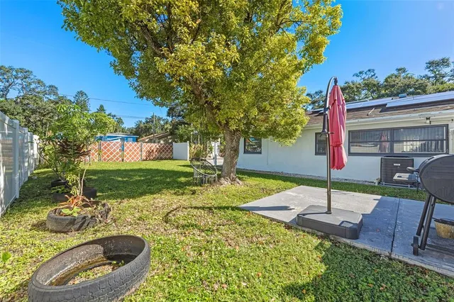 a view of a backyard with sitting area