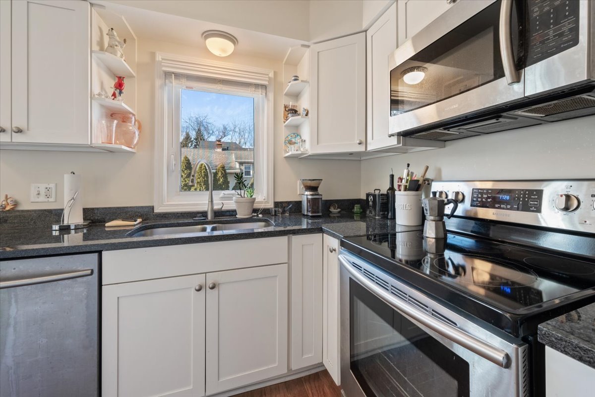 601 Ridge Road, Unit 202 Wilmette, IL 60091 - Photo 11 of 17 a kitchen with stainless steel appliances white cabinets and a sink