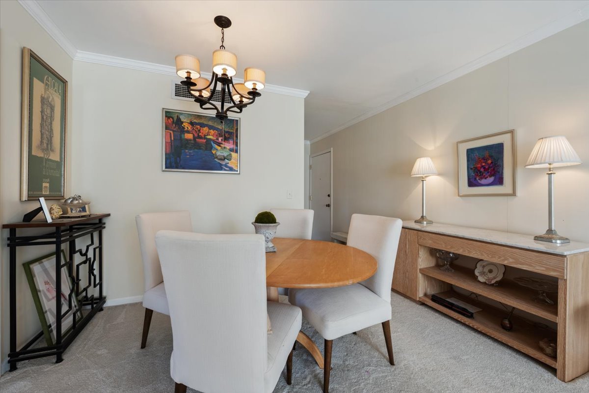 601 Ridge Road, Unit 202 Wilmette, IL 60091 - Photo 9 of 17 a dining room with furniture and chandelier