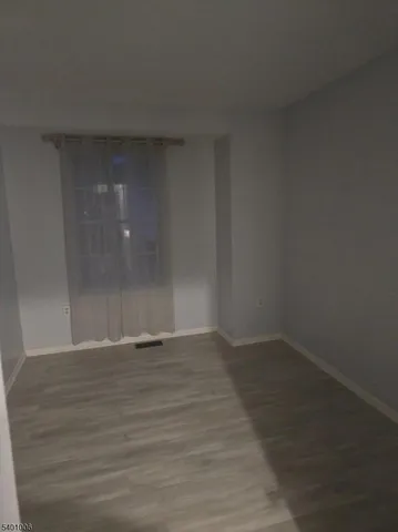 a view of an empty room and wooden floor