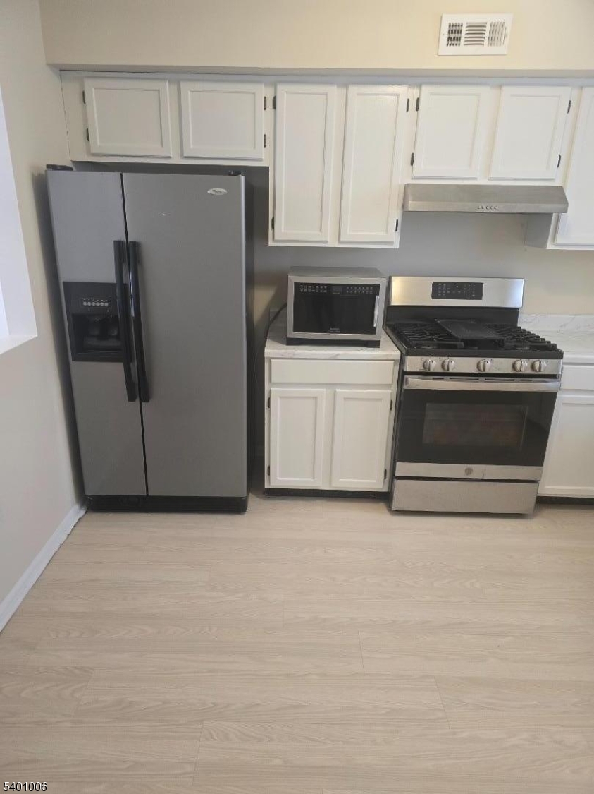 754 Darlington Drive Old Bridge, NJ 08857 - Photo 2 of 19 a kitchen with a stove and a refrigerator