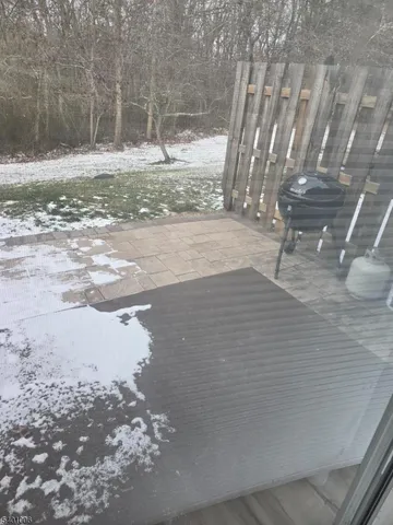 a view of a yard with wooden fence