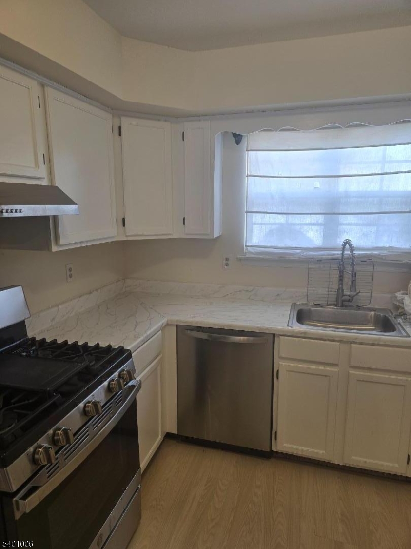 754 Darlington Drive Old Bridge, NJ 08857 - Photo 4 of 19 a kitchen with stainless steel appliances a sink and cabinets