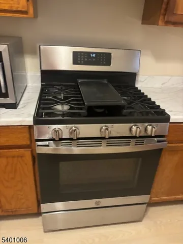 a stove top oven sitting inside of a kitchen