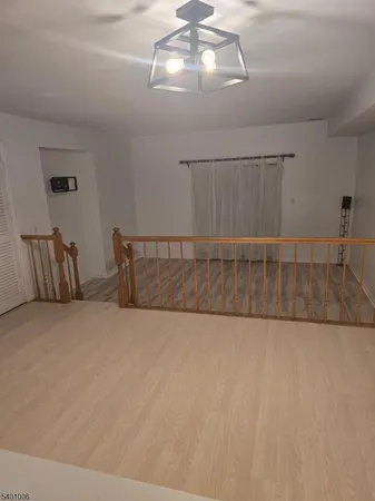 a view of a room with window and ceiling fan