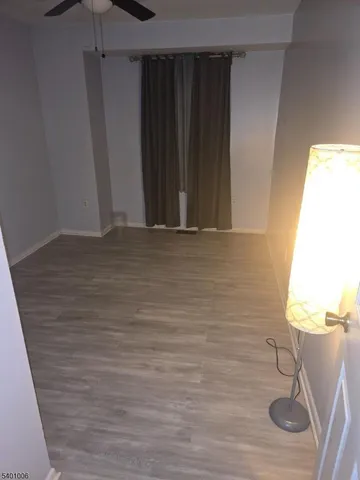 a view of a closet area with wooden floor