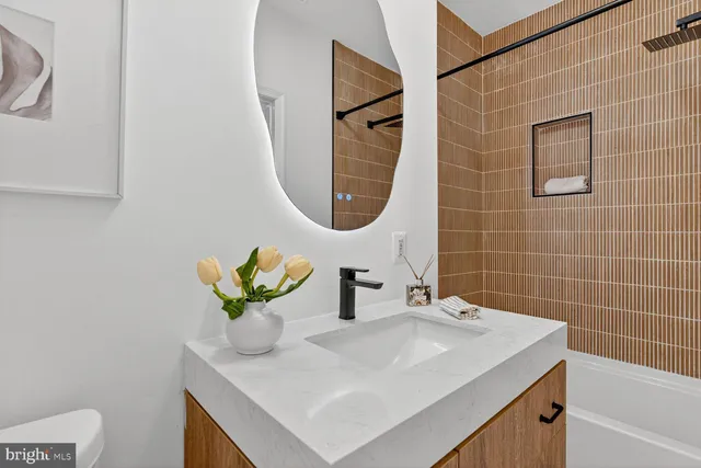 an empty room with ceiling fan and window