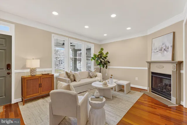 a living room with furniture a fireplace and a table