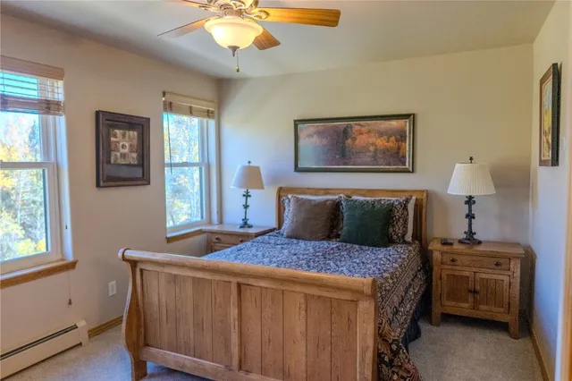 a bedroom with a bed a lamp and a window