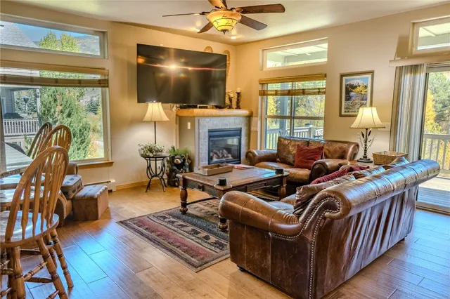 a living room with furniture a fireplace and a flat screen tv