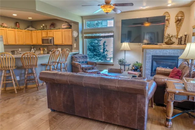 a kitchen with a table chairs refrigerator and cabinets