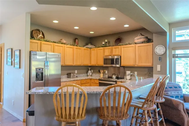 a dining room with furniture a rug and wooden floor
