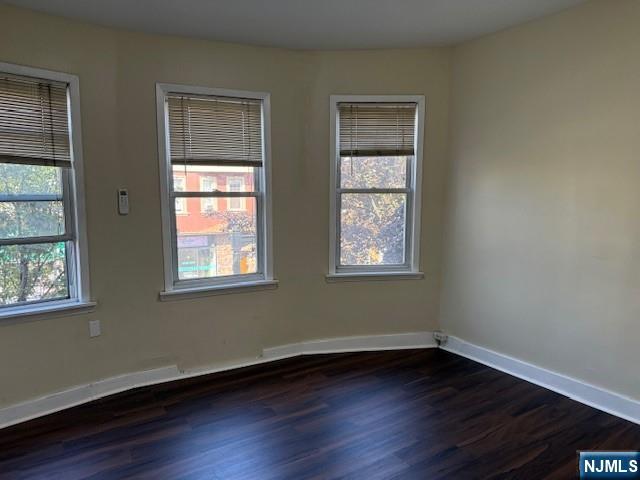234 Paterson Avenue, Unit 1 East Rutherford, NJ 07073 - Photo 5 of 15 a view of an empty room with wooden floor and a window