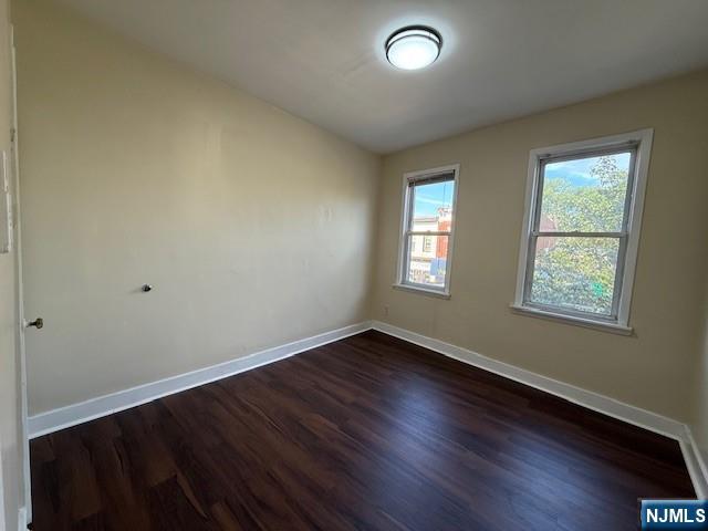 234 Paterson Avenue, Unit 1 East Rutherford, NJ 07073 - Photo 7 of 15 an empty room with wooden floor and windows