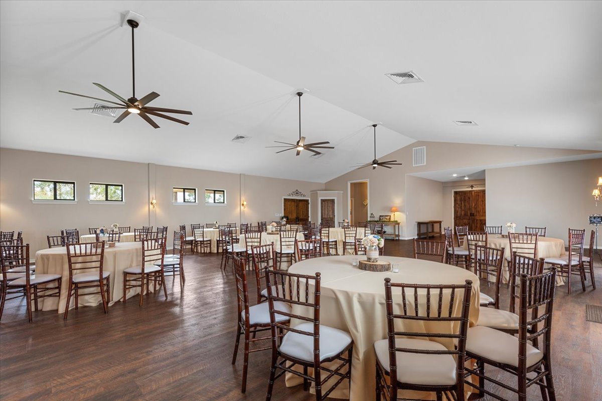 178 Pine Tree Loop Bastrop, TX 78602 - Photo 12 of 40 a view of a a dining room and livingroom with furniture wooden floor a chandelier