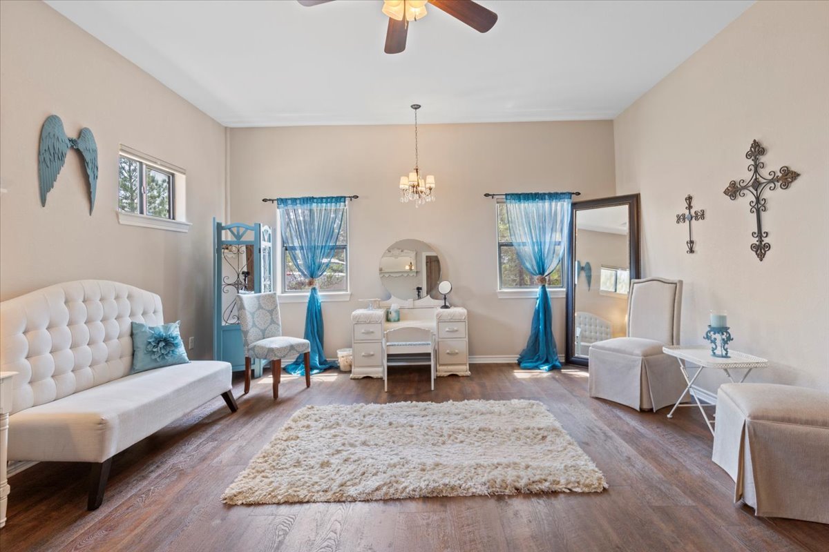 178 Pine Tree Loop Bastrop, TX 78602 - Photo 26 of 40 a living room with furniture and a chandelier