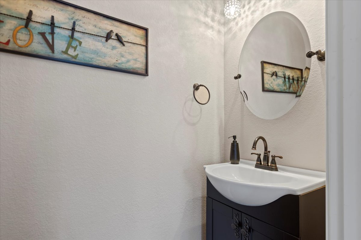 178 Pine Tree Loop Bastrop, TX 78602 - Photo 27 of 40 a bathroom with a sink and mirror