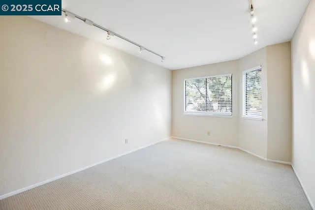 an empty room with windows and closet