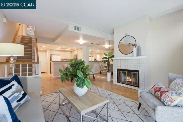 a living room with furniture a rug and a fireplace