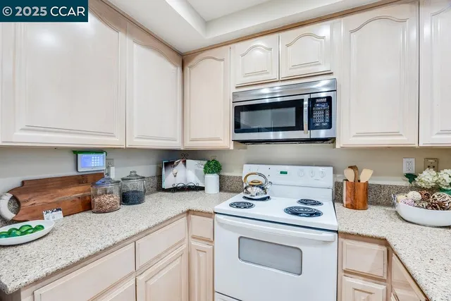 a kitchen with appliances a sink and cabinets