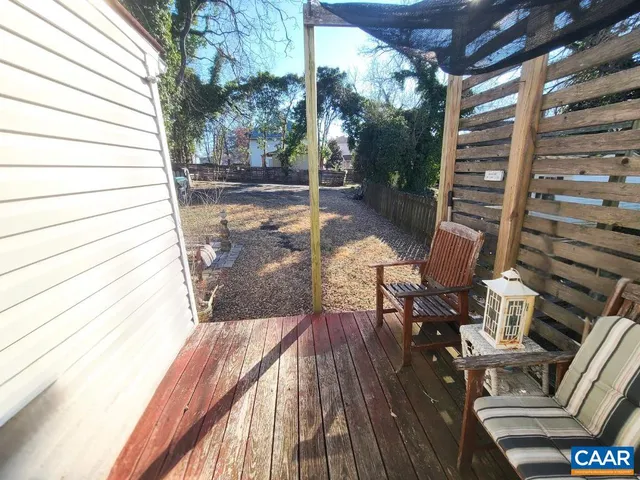 a view of balcony with wooden floor and outdoor seating