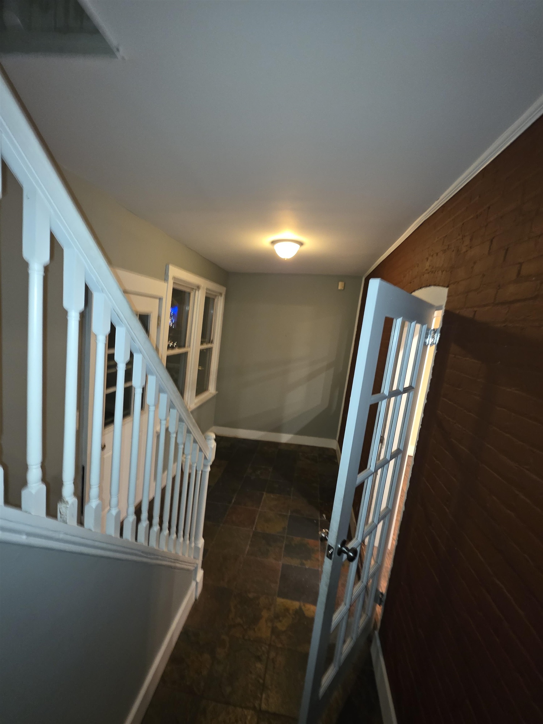 365 Avenue A, Unit 1 Bayonne, NJ 07002 - Photo 12 of 14 a view of staircase with lots of frames and a fan