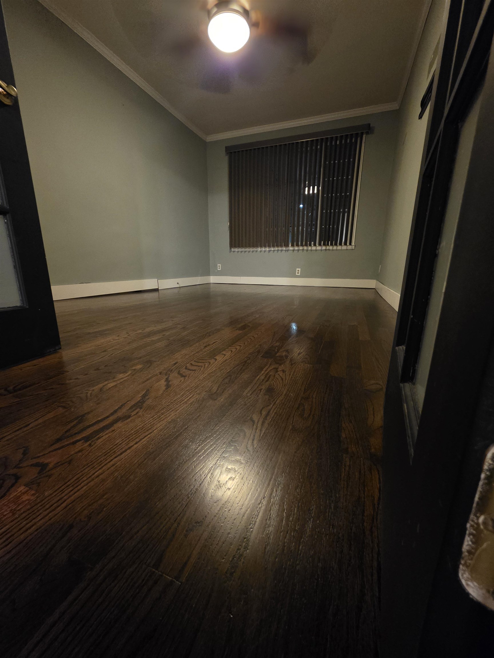 365 Avenue A, Unit 1 Bayonne, NJ 07002 - Photo 4 of 14 wooden floor in an empty room with a window