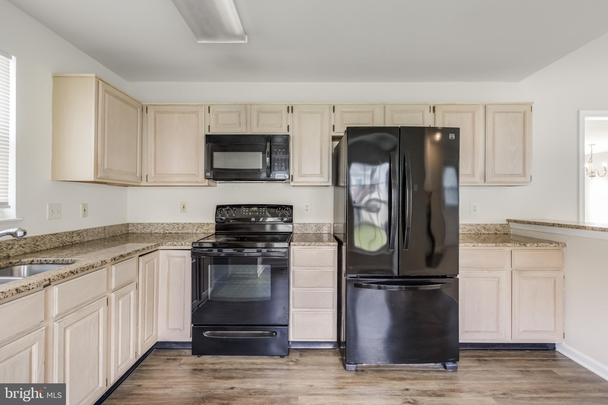 936 Millponds Court Bowie, MD 20721 - Photo 14 of 57 a kitchen with a sink and a stove