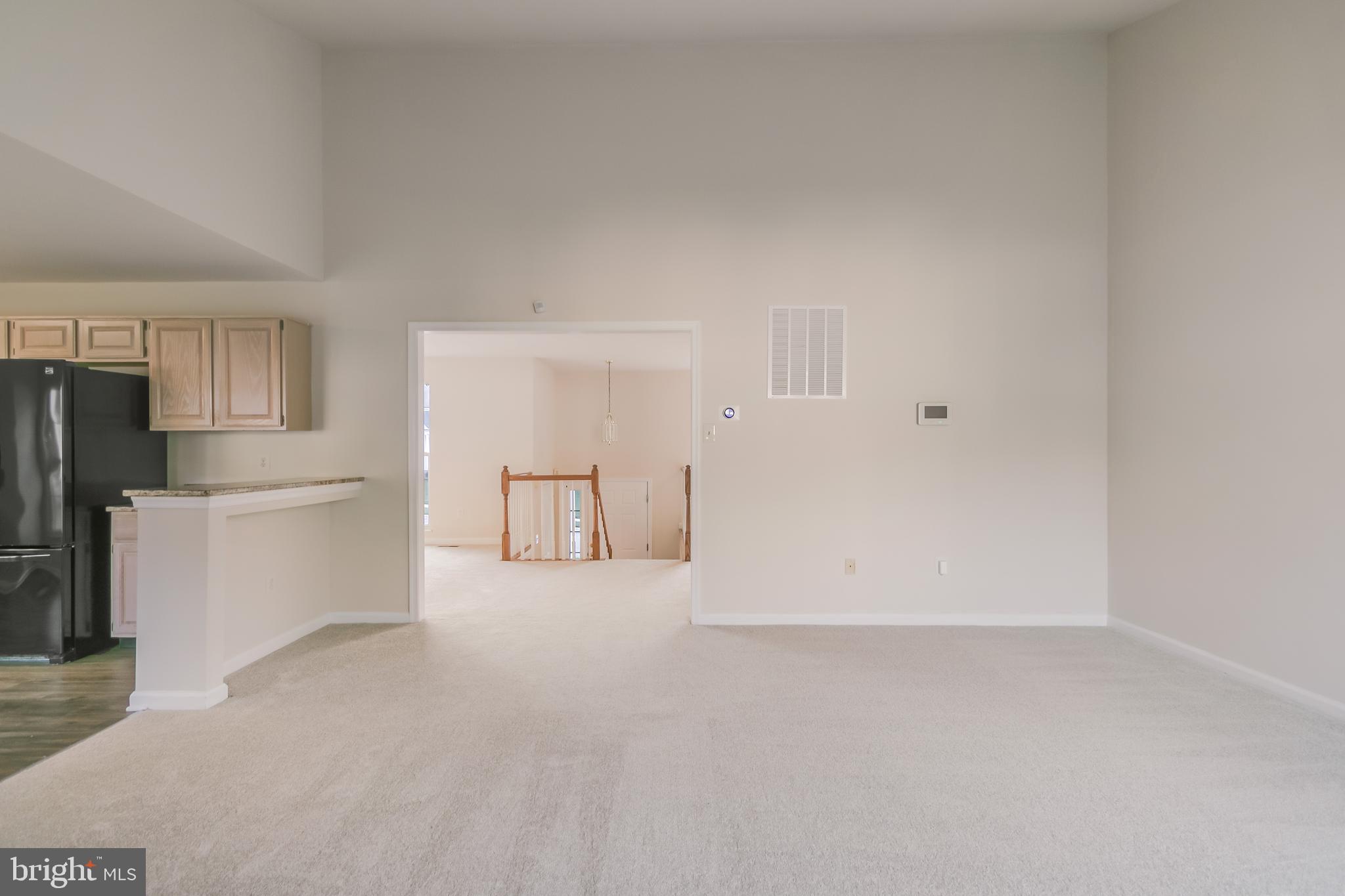 936 Millponds Court Bowie, MD 20721 - Photo 22 of 57 a view of a kitchen with refrigerator and white cabinets