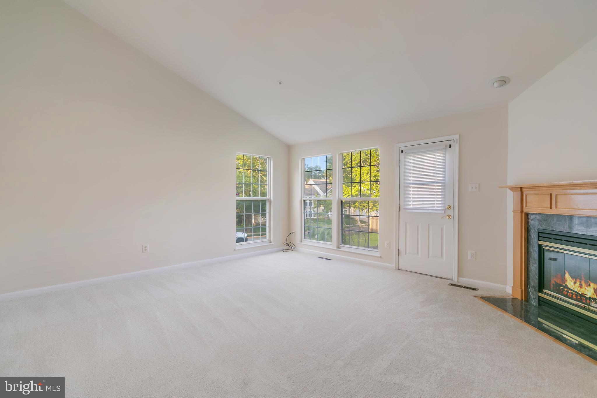 936 Millponds Court Bowie, MD 20721 - Photo 29 of 57 a view of an empty room with a fireplace and a window