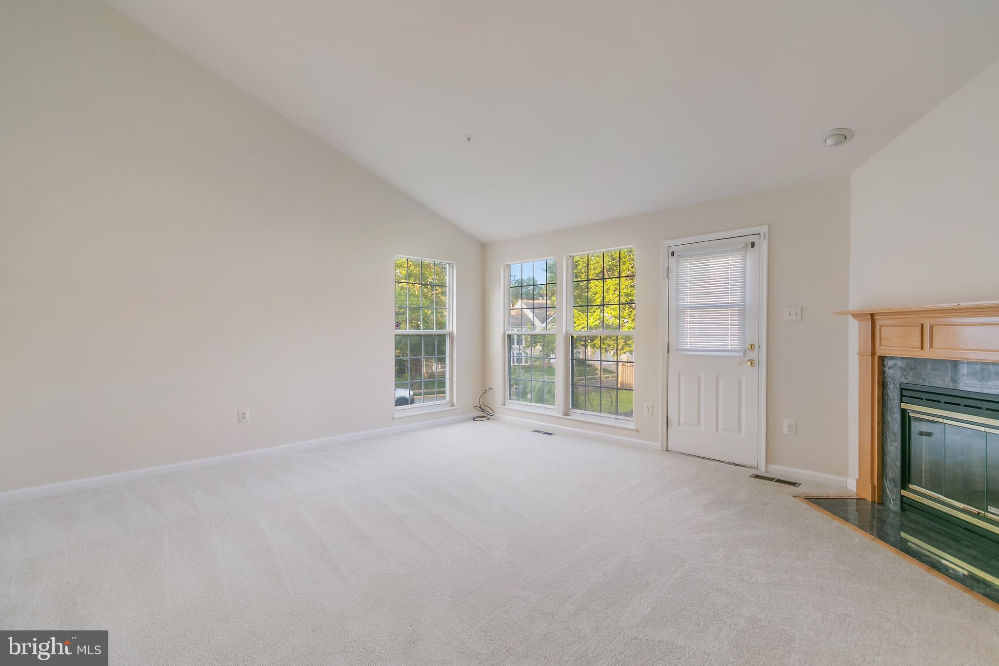 936 Millponds Court Bowie, MD 20721 - Photo 30 of 57 an empty room with windows and fireplace