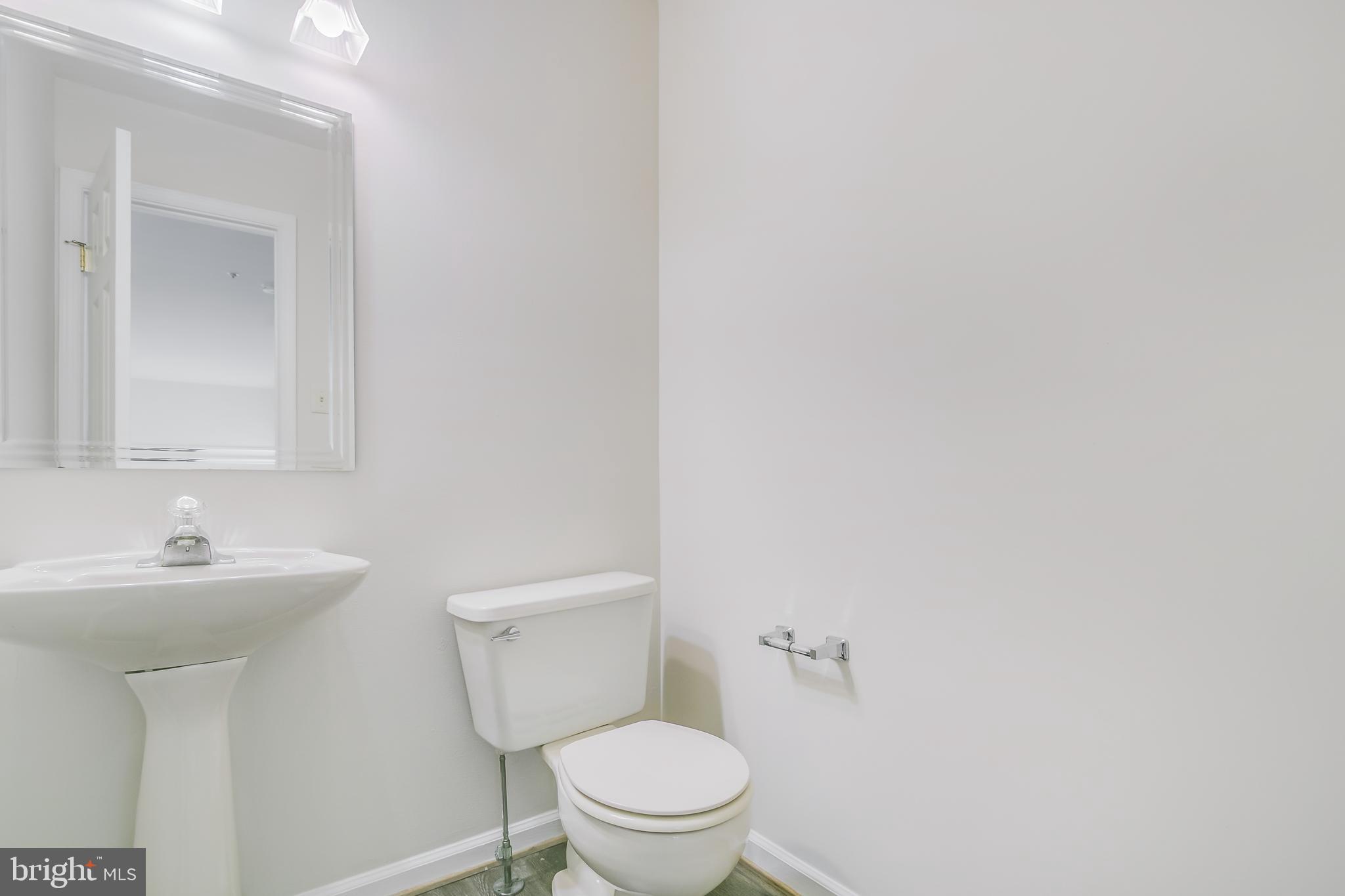 936 Millponds Court Bowie, MD 20721 - Photo 42 of 57 a bathroom with a toilet a sink and mirror