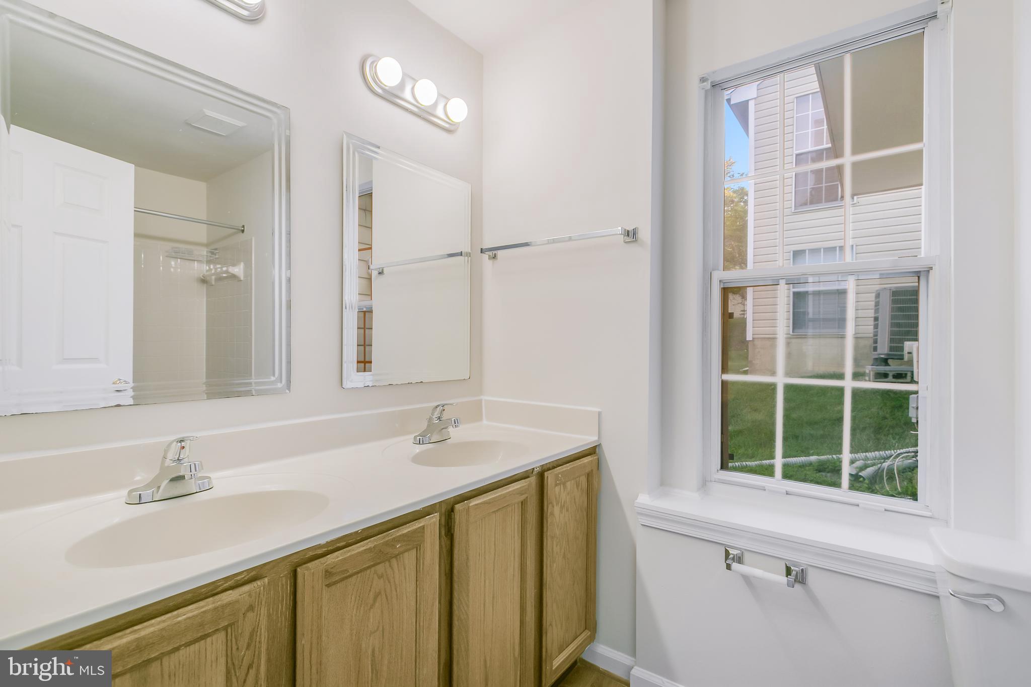 936 Millponds Court Bowie, MD 20721 - Photo 55 of 57 a bathroom with a sink and a mirror