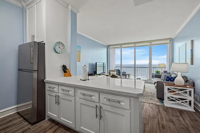 a very nice looking living room with a large window and wooden floors