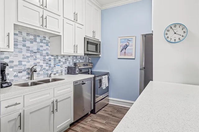 a kitchen with stainless steel appliances granite countertop a white stove top oven and sink