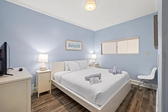 a bedroom with a bed and a large window