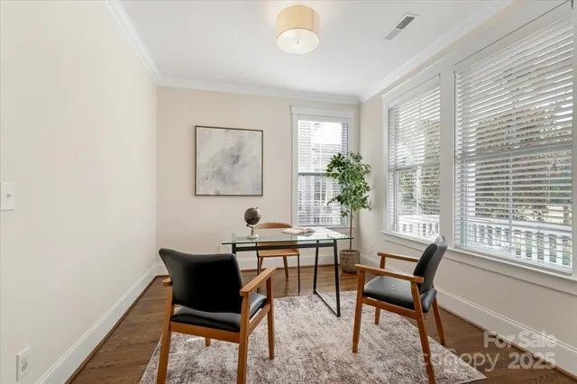 a view of a dining room with furniture and a window