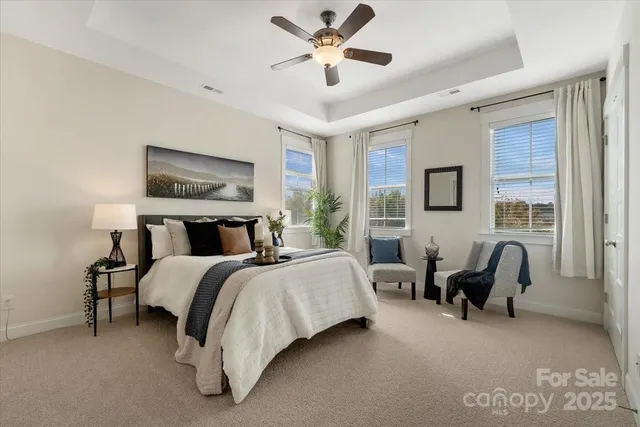 a spacious bedroom with a bed and a couch