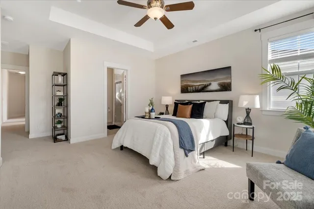 a bedroom with a bed and ceiling fan