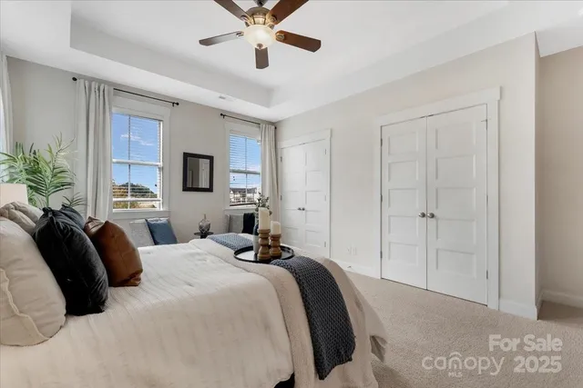 a bedroom with a large bed and a chandelier