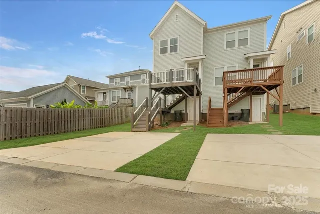 an aerial view of residential houses with outdoor space and street view