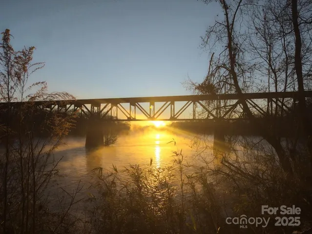a view of a lake with trees all around