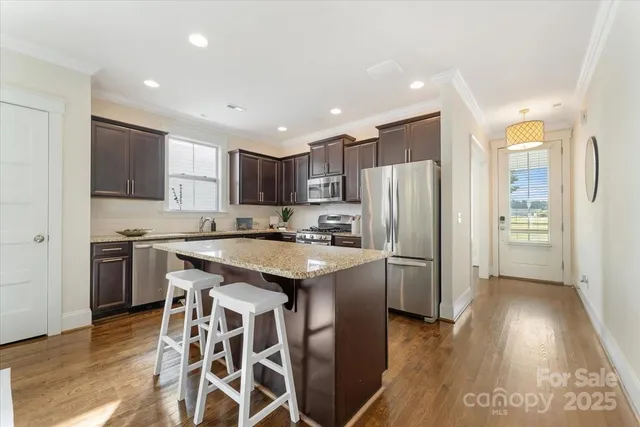 a kitchen with a refrigerator a sink and cabinets