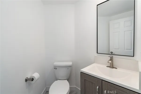 a bathroom with a sink a toilet and mirror