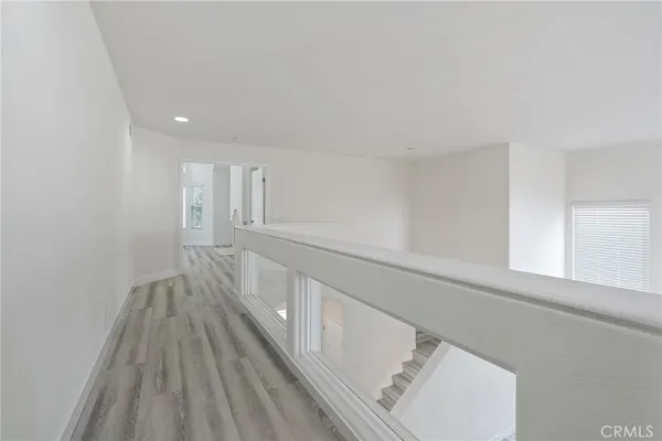 a view of hallway with wooden floor