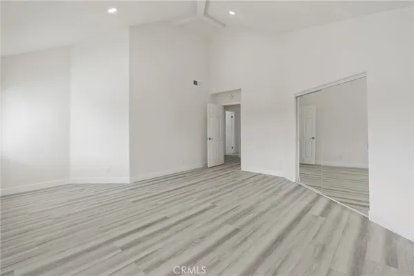 a view of an empty room with wooden floor