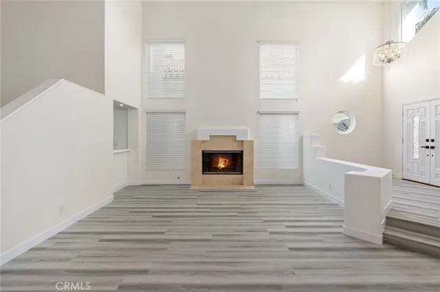 a view of a livingroom with wooden floor and a fireplace